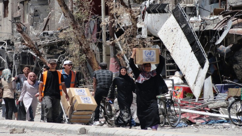 دخول 12 قافلة مساعدات إنسانية من أصل 23 إلى حي الوعر بحمص