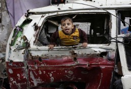 طفل يلعب داخل آلية مدمرة في غزة امس